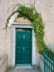 Green door with ivy frame and iron fence, Roscommon, Ireland
