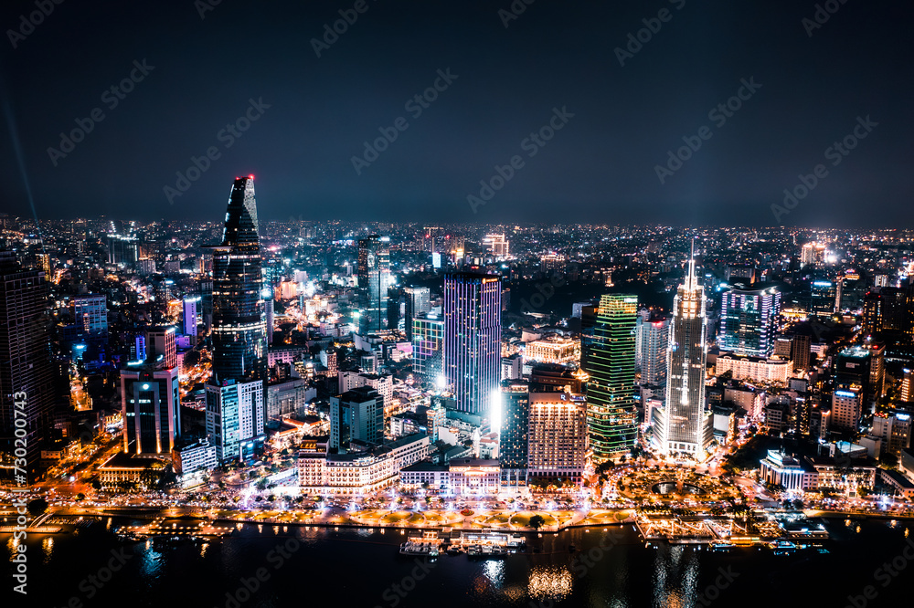 Poster Aerial drone photo - Skyline of Saigon (Ho Chi Minh City) at night. Vietnam