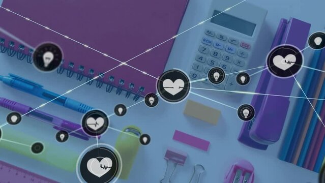 Animation of network of health and idea icons over school stationery on desk