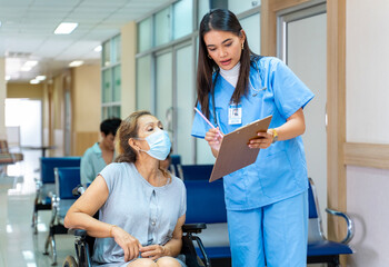 Asian nurse is asking patient for personal information and medical record data for treatment and...