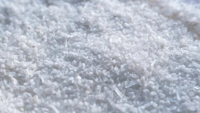 White Monosodium Glutamate (MSG) crystals falling down close up