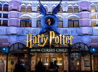 Fototapeta premium London. UK- 02.04.2024. A night time view of the main display on the facade of the Palace Theatre for the show Harry Potter and the Curse Child.
