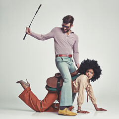 Retro, man and woman or riding crop in studio with piggyback, portrait and funny face for vintage...