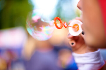 Closeup, blowing bubbles and outdoor with woman, summer and weekend break with event. Party, person...