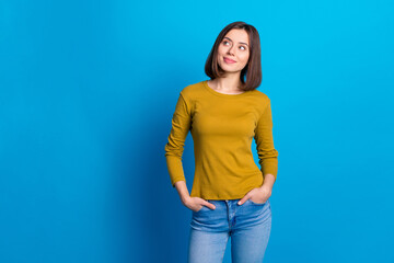 Photo of cheerful dreamy woman wear shirt smiling looking empty space isolated blue color background