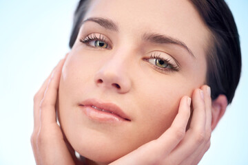 Beauty, skincare and portrait of woman in studio with health, cosmetic and facial routine. Wellness, glow and closeup of young female person with face dermatology treatment by blue background.