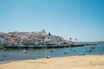 Naklejka na ściany i meble Old village of Ferragudo and Portimao town at background in Algarve region, South Portugal