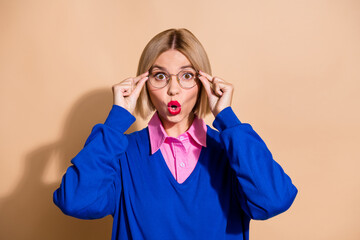 Portrait of impressed agent lady arms touch eyewear pouted lips unbelievable reaction isolated on...