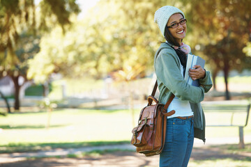 Park, student and portrait of woman with books for studying, learning and reading outdoors. Education, happy and person with bag, textbooks and headphones relax on campus for university or college