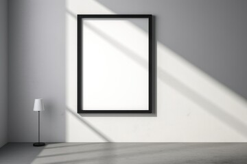 A black frame on a wall with a shadow