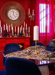In a vibrant setting, a red room hosts a leopard-print table and plush blue chairs, highlighted by...