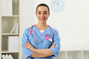 Mammologist with pink ribbon in hospital. Breast cancer awareness