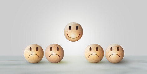 Smile icon wooden ball, sad face in dark side on wooden block cube for positive mindset selection. Concept of recruiting