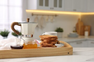 Breakfast served in kitchen. Tray with toasts, honey, jam and coffee on white table. Space for text