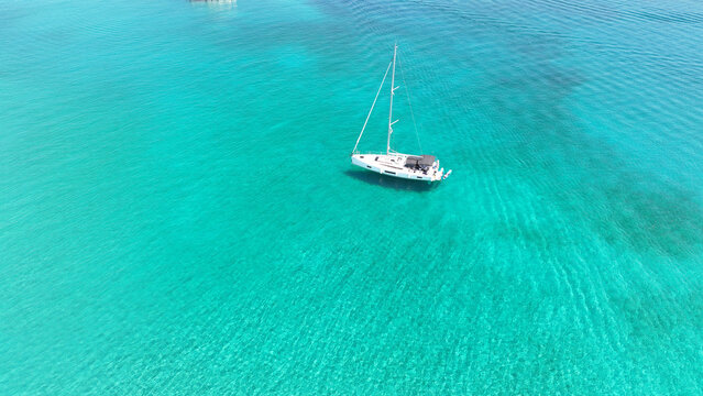 Aerial drone photo of azure paradise blue lagoon of Panteronisi a small islet complex between Paros and Antiparos islands visited by yachts and sail boats, Cyclades, Greece