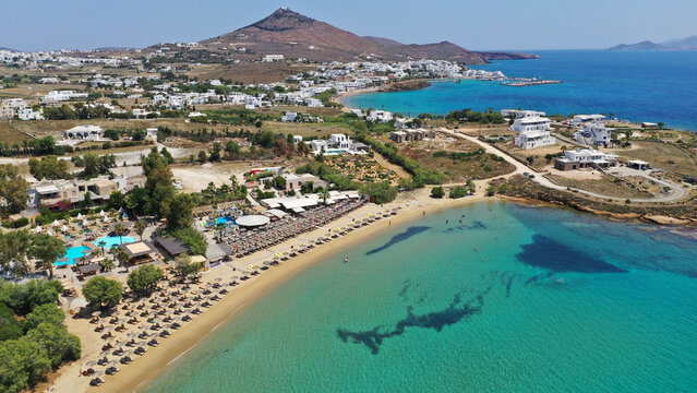 Aerial drone photo from sandy organised with umbrellas and sun beds beach of Pounta with crystal clear emerald sea, Paros island, Cyclades, Greece