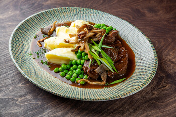 Stewed beef veal cheeks with mashed potatoes on plate