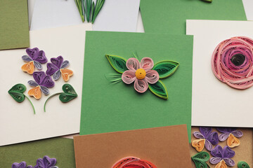 quilling card with flowers. making greeting cards. Beautiful flowers designs. Paper quilling, colorful paper flowers. Hand made of paper quilling technique. Handicraft at home. Hobby, home office.
