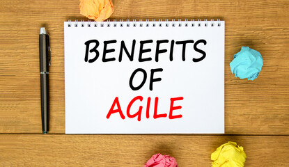 Fototapeta premium Benefits of agile symbol. Concept words Benefits of agile on beautiful white note. Beautiful wooden background. Black pen. Colored paper. Business benefits of agile concept. Copy space.