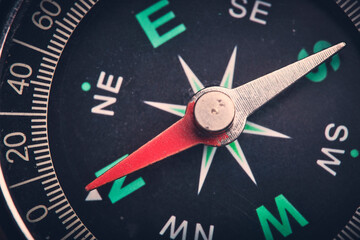 Dial compass in closeup, arrow indicates direction south. - obrazy, fototapety, plakaty