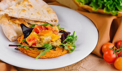Creamy Lebanese Hummus and pepper rolls on plates