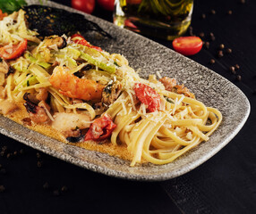 Seafood pasta with octopus and shrimps on plate