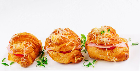 Fresh croissants stuffed with ham and cheese