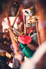 Heart shaped padlock among many old rusty locks.