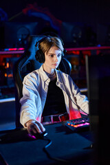 female gamer in headphones looking at computer monitor while thinking on game strategy, cybersport © LIGHTFIELD STUDIOS