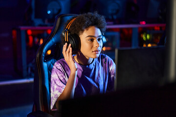 african american gamer in headphones looking at monitor while thinking on game strategy, cybersport © LIGHTFIELD STUDIOS