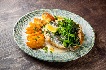 Fried dorado fish with Potato country style fried and sauce on plate