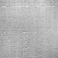 Gray decorative plaster on the wall with pressed horizontal stripes