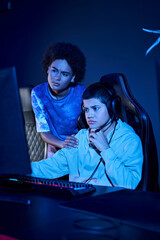 confused interracial women focused on a cybersport gaming session, zoomer age female friends