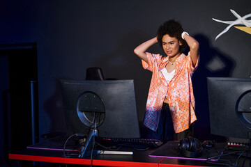 frustrated african american woman with curly hair looking at computer and stressing out, gamer © LIGHTFIELD STUDIOS