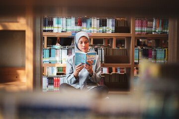 Happily young muslim woman enjoying books at the library. library concept