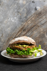 Flavorful quinoa and black bean vegetarian burger, bursting with textures and tastes. A delicious, healthy option for vegan food enthusiasts.