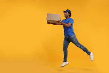 Happy courier running to deliver parcel on orange background, space for text