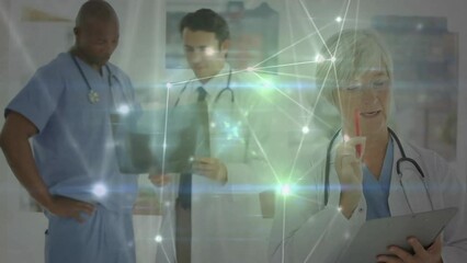 Animation of glowing communication network over diverse male and female doctors at work in hospital - Powered by Adobe
