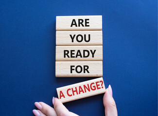 Change symbol. Wooden blocks with words Are you ready for a new change. Businessman hand. Beautiful deep blue background. Business and change concept. Copy space.