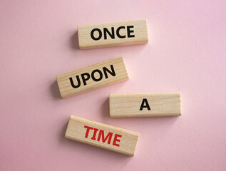 Once upon a time symbol. Concept words. Once upon a time on wooden blocks. Beautiful pink background. Business and Once upon a time concept. Copy space