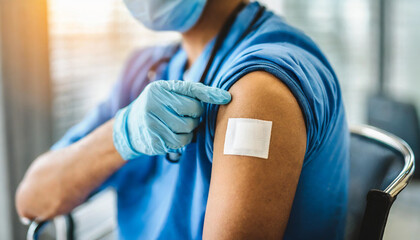 shoulder with bandaid after COVID vaccine, symbolizing vaccination and healthcare