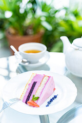 tea with lavender croissant and raspberry cheesecake for breakfast. white cup