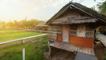 Houses nestled in a riverside village, surrounded by trees and gardens