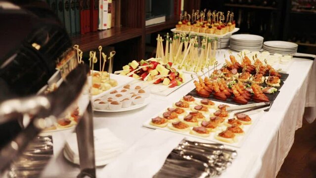Canapes and sandwiches with vegetables on table during banquet