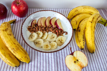 Zdrowe śniadanie z jogurtem naturalnym, granolą, jabłkiem i bananami © Monika