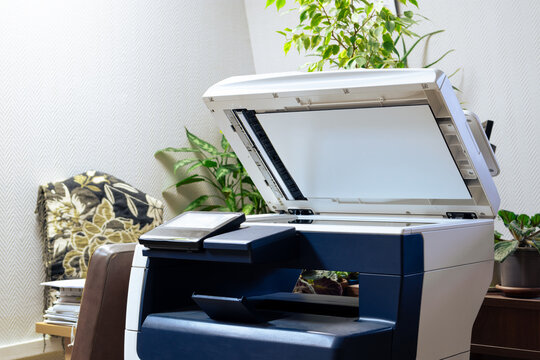Copy machine with open lid in the office