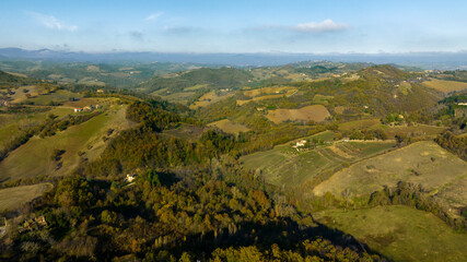 Fototapeta na wymiar Aerial view on the Irpinia countryside in the province of Avellino, Italy. Among the cultivated fields and woods in the mountains there is some isolated house. 