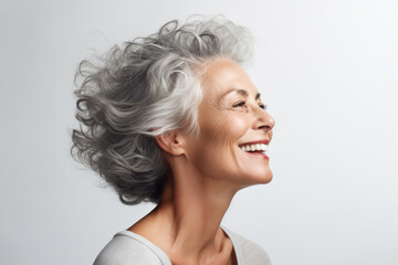 Joyful senior woman with gray hair laughing. Age positivity and beauty.