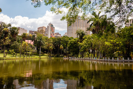 Belo Horizonte Municipal Park, during a beautiful sunny day with the sky's clouds reflected in the lake.