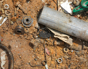 rusty and pieces of iron at the bottom of the container of a recycling landfill